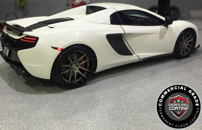 ConcreteShieldCoatingFlake Our robust Concrete Shield Coating® Hybrid Epoxy Primer Coat forms the strong base needed for a lasting epoxy floor. After applying the primer, we broadcast vinyl flakes, offering a variety of colors to personalize your garage floor.