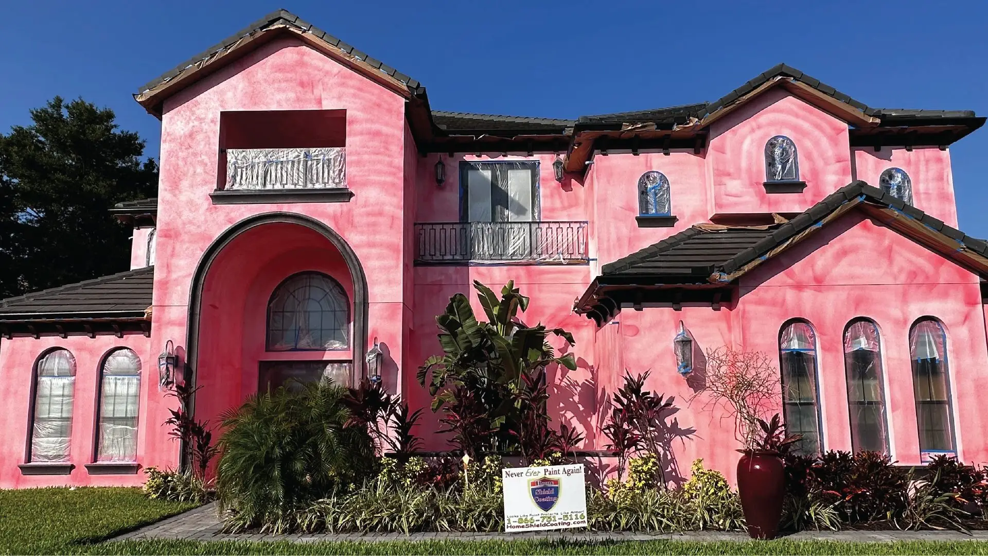 Pink stucco home before Home Shield Coating exterior wall coating application