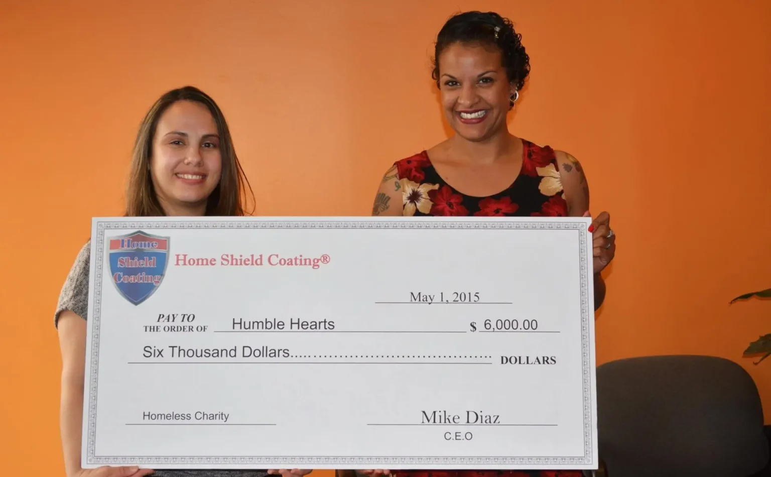 Home Shield Coating presenting a donation check to Humble Hearts homeless charity